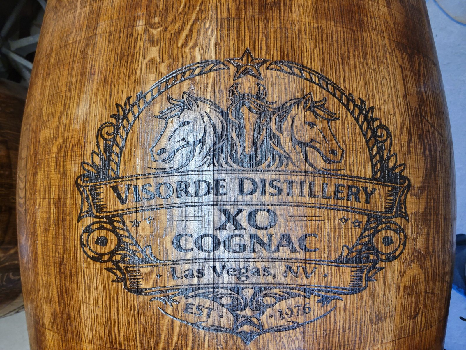 Custom distillery logo engraved on oak barrel